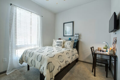 Apartment bedroom featuring a bed and window